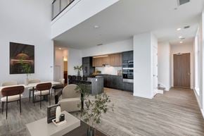 Calgary apartment for rent - A modern kitchen with a dining table and chairs.