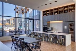 Calgary apartment for rent - A modern dining area with a long table and chairs.