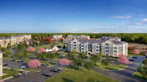 Swanzey apartment for rent - A large building with a parking lot in front of it.
