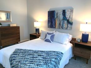 Swanzey apartment for rent - A bedroom with a bed, nightstands, and a painting on the wall.