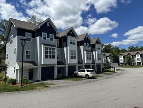 Nashua townhouse for rent - A row of houses with a car parked in front of them.
