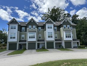 Nashua townhouse for rent - A large, modern house with a grey and white exterior.