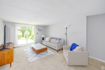 Somersworth apartment for rent - A living room with a white couch and a wooden coffee table.