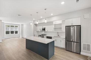 East Providence townhouse for rent - A modern kitchen with a large island and stainless steel appliances.