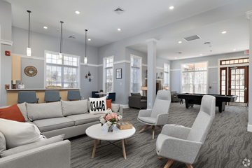 Swanzey apartment for rent - A living room with grey and white furniture and a grey carpet.