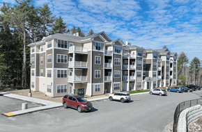 Swanzey apartment for rent - A red car is parked in front of a building.
