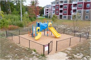 Somersworth apartment for rent - A playground with a yellow slide and a blue slide.