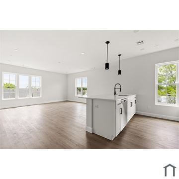 Lynn apartment for rent - A kitchen with white cabinets and a wooden floor.