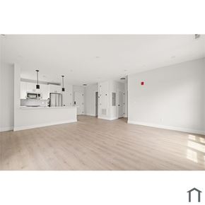 Lynn apartment for rent - A spacious, empty room with wooden flooring and white walls.