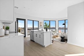 Beverly apartment for rent - A modern kitchen with white cabinets and a large island.
