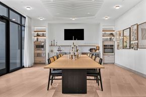 Haverhill apartment for rent - A modern dining room with a long wooden table and chairs.