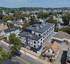 Lynn apartment for rent - A large building with a black roof is in the center of a residential area.