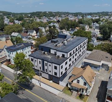 Lynn apartment for rent - A large building with a black roof is in the center of a residential area.