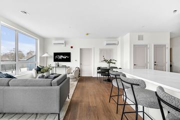 Marlborough apartment for rent - A living room with a grey couch and a wooden floor.