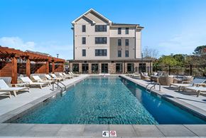 Marlborough apartment for rent - A large building with a pool in front of it.
