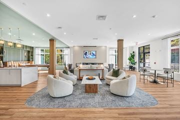 Marlborough apartment for rent - A modern living room with a white sofa set and a television.
