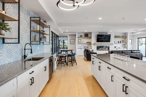 Beverly apartment for rent - a large kitchen with white cabinets and a living room