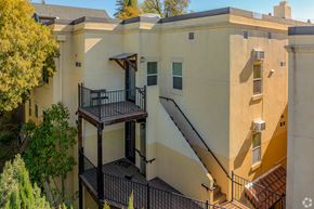 Auburn apartment for rent - A building with a balcony and stairs.