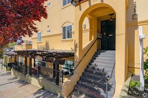 Auburn apartment for rent - A building with a staircase leading to a black door.