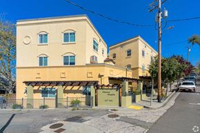 Auburn apartment for rent - A yellow building with a sign that reads "Almonds" is located on a street corner.