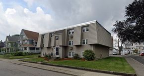 Worcester apartment for rent - a large apartment building with a roof on the side of a street