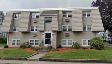 Worcester apartment for rent - the front of an apartment building with a lawn