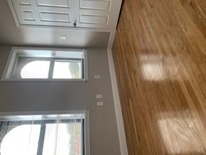 Brighton apartment for rent - A room with wooden floors and white walls.