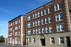 Worcester apartment for rent - A large red brick building with white trim and windows.