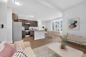 Washington apartment for rent - A living room with a couch, a coffee table, and a painting on the wall.