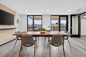 Washington apartment for rent - A modern dining room with a wooden table and chairs.