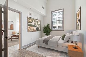 Baltimore apartment for rent - a bedroom with a bed and a door to a living room