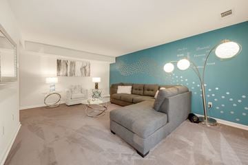 Columbia apartment for rent - A living room with a grey sofa and a white coffee table.