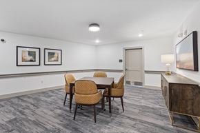 Raleigh apartment for rent - A conference room with a table, chairs, and pictures on the wall.