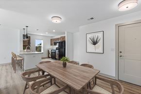 Raleigh apartment for rent - A modern dining room with a wooden table and chairs.