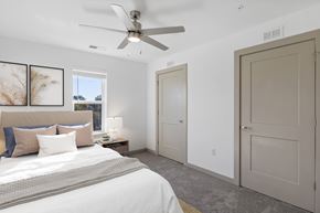 Raleigh apartment for rent - A bedroom with a large bed and a ceiling fan.