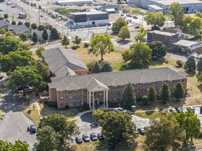 Dayton apartment for rent - A large apartment complex with a parking lot in front.
