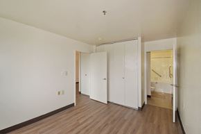 Baltimore apartment for rent - a bedroom with white walls and wood floors and a closet
