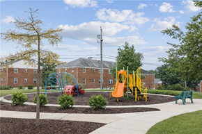 Baltimore apartment for rent - a playground in a park in front of a brick building