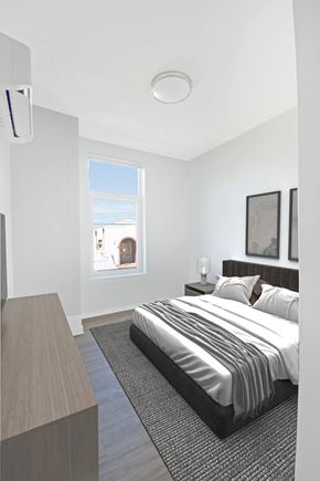 Washington apartment for rent - A bedroom with a large bed and a window overlooking a cityscape.