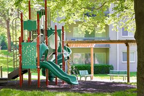 Columbia apartment for rent - A playground with a green slide and a red structure.