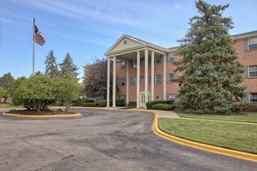 Dayton apartment for rent - A building with a flag on top of it.