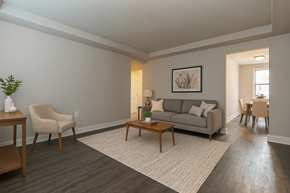Brentwood apartment for rent - A living room with a grey couch, a chair, a coffee table, and a potted plant.