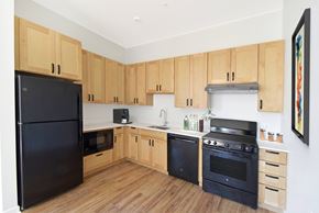 Washington apartment for rent - A kitchen with wooden cabinets and black appliances.
