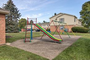 Dayton apartment for rent - A playground with a green, yellow and red slide.