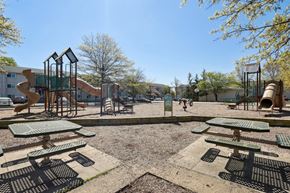 Alexandria apartment for rent - A playground with a slide, swings, and picnic tables.