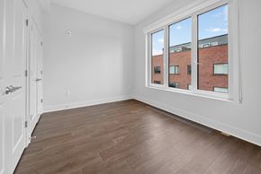 Washington apartment for rent - Empty room with a window overlooking a brick building.