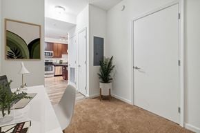 Silver Spring apartment for rent - a room with a desk and a door to a kitchen and a living room