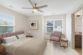 Durham apartment for rent - A bedroom with a bed, chair, and a painting on the wall.