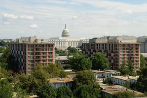 Washington apartment for rent - A view of the Capitol building from a distance with trees in the foreground.