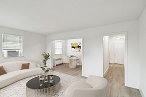 Baltimore apartment for rent - a living room with a white couch and a coffee table